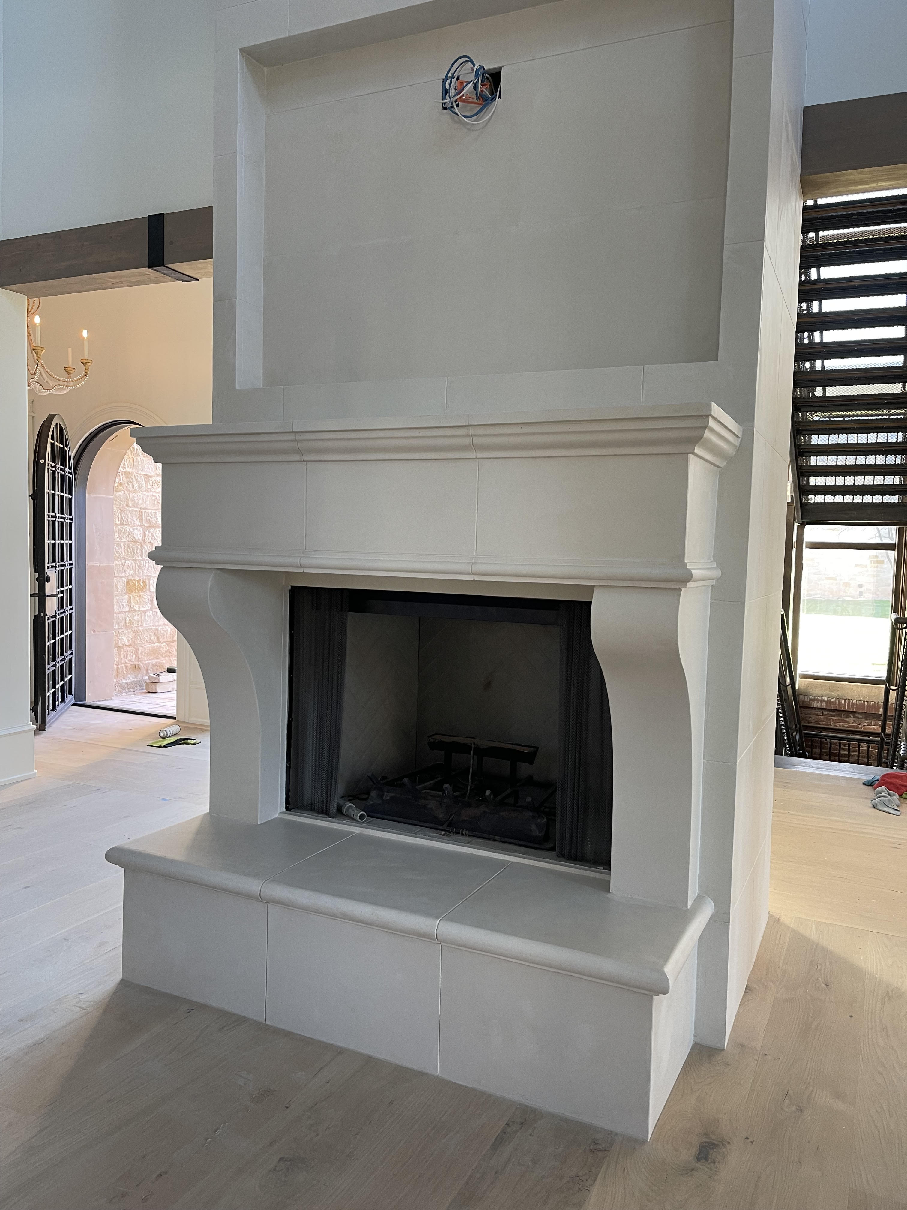Minimalist light gray cast stone fireplace surround