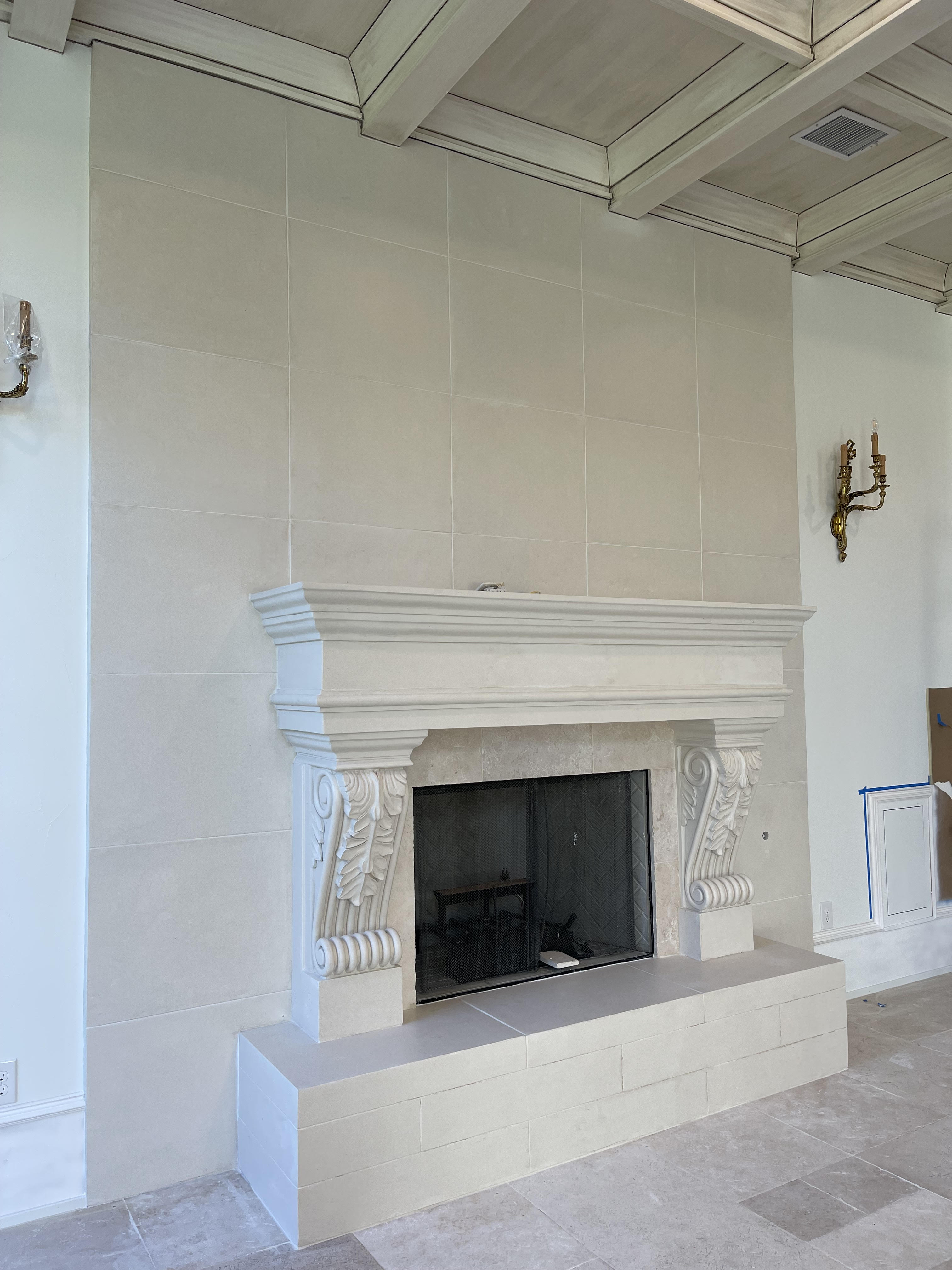 Cast stone fireplace with decorative corbel details
